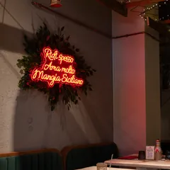L’insegna al neon nella sala della ristomacelleria di Milano